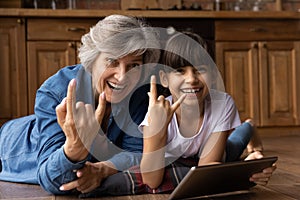 Portrait of smiling mature grandmother have fun with granddaughter