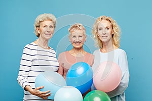 Portrait of smiling mature ladies with balloons