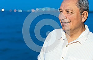 Portrait of a smiling mature Latino man standing outdoors