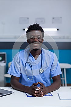Portrait of smiling medical nurse wearing blue scrubs and stethoscope