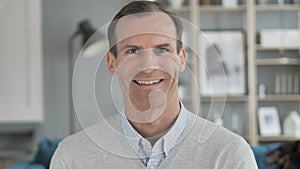 Portrait of Smiling Middle Aged Man Looking at Camera