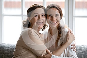 Portrait of smiling middle-aged mom and adult daughter