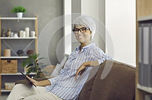 Portrait of smiling middle-aged woman use tablet