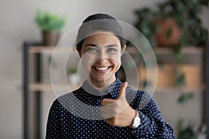 Portrait of smiling Indian woman show thumb up give recommendation photo