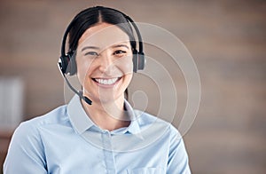 Portrait of a smiling mixed race call centre agent looking happy and positive while wearing a headset. Female customer
