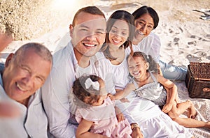 Portrait of smiling mixed race family with little girls taking selfies together at the beach. Adorable little kids