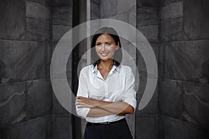 Portrait of a Smiling Mixed Races Business Woman, Crossed Arm