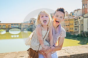 Portrait of smiling mother and baby girl in florence, italy