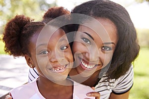 Portrait Of Smiling Mother With Daughter In Park