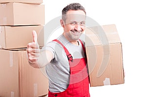 Portrait of smiling mover man showing like gesture