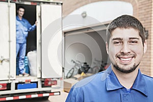 Portrait of smiling mover with moving truck in the background photo