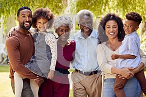 Portrait Of Smiling Multi-Generation Family At Home In Garden Together