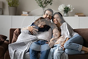 Portrait of smiling multiethnic family with kids relax at home