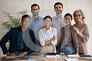 Portrait of happy diverse businesspeople posing at workplace together