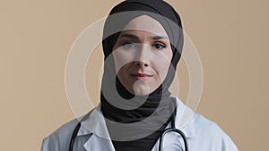 Portrait smiling muslim arab female pharmacist dermatologist professional psychologist in hijab white coat look at