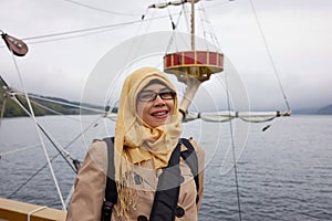 Portrait of smiling muslim woman on board Hakone sightseeing cruise ship at Lake Ashi