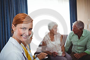 Portrait of a smiling nurse with seniors