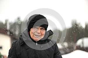 Portrait of smiling old senior woman looking at camera