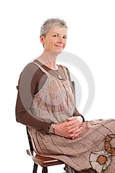 Portrait of smiling older woman sitting sideways