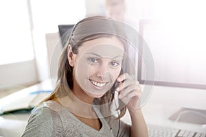 Portrait of smiling operator with headset working
