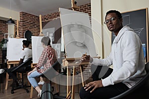 Portrait of smiling painter student attenting drawing class