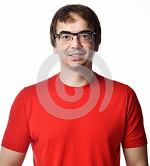 Portrait of smiling positive excited unshaved man in glasses and red t-shirt retelling a story over white background photo