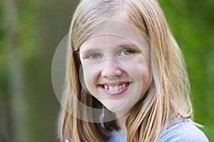 Portrait Of Smiling Pre Teen Girl Outdoors