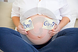 Smiling pregnant woman waiting for a boy or girl