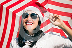 Portrait of a smiling pretty girl in Santa Claus hat