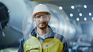 Portrait of Smiling Professional Heavy Industry Engineer / Worker Wearing Safety Uniform, Goggles