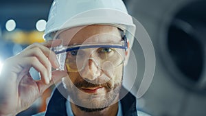 Portrait of Smiling Professional Heavy Industry Engineer / Worker Wearing Safety Uniform, Goggles