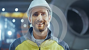 Portrait of Smiling Professional Heavy Industry Engineer / Worker Wearing Safety Uniform and Hard