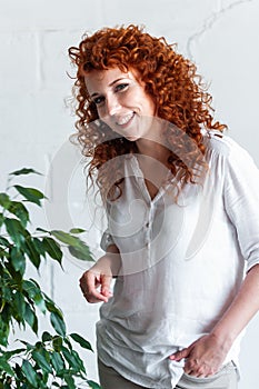 Portrait of a smiling red-haired curly woman