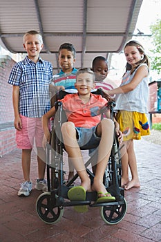 Portrait of smiling schoolkids in corridor