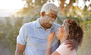 Portrait Of Smiling Senior African American Couple In Garden At Home