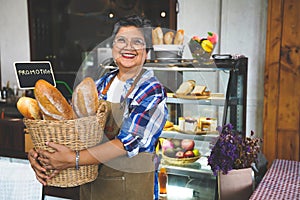 Portrait of a smiling senior Asian barista, hands on pockets, welcoming the customer in a cozy coffee shop. Small business owner