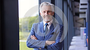 Portrait Of Smiling Senior Businessman CEO Chairman Standing Inside Modern Office Building