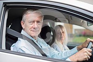 Portrait Of Smiling Senior Couple On Car Journey Together