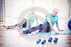 Portrait of smiling senior couple doing yoga
