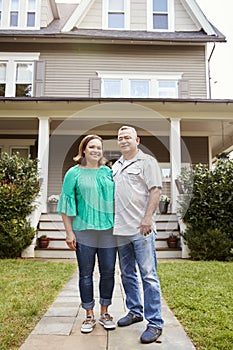 Portrait Of Smiling Senior Couple In Front Of Their Home