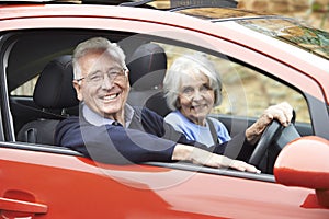 Portrait Of Smiling Senior Couple Out For Drive In Car