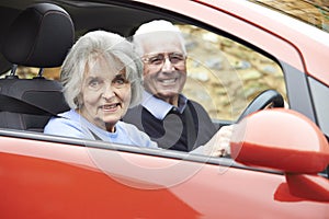 Portrait Of Smiling Senior Couple Out For Drive In Car