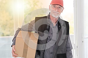 Portrait of smiling senior deliverer, light effect