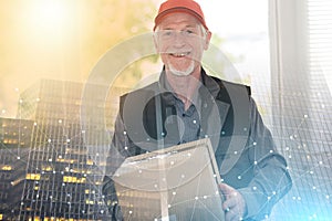 Portrait of smiling senior deliverer, light effet; multiple exposure