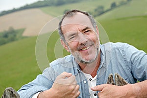 Portrait of smiling senior farmer in the fields photo