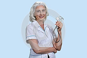 Portrait of smiling senior female doctor with stethoscope.