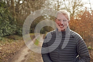 Portrait Of Smiling Senior man On Walk In Countryside Exercising During Covid 19 Lockdown