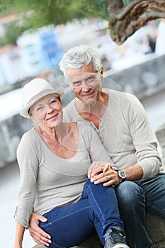 Portrait of smiling senior trendy couple in the streets