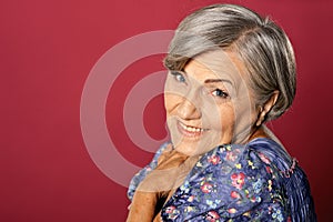 Portrait of smiling senior woman posing in studio