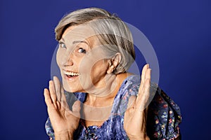 Portrait of smiling senior woman posing in studio